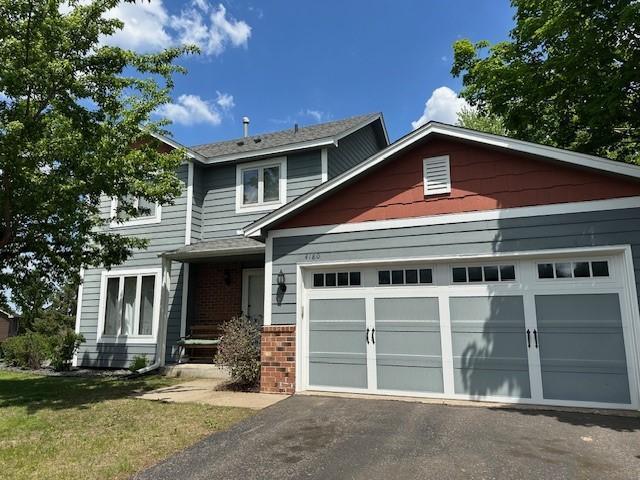 4180 Reading Rd, Eagan, MN 55123 - view of front of house with brick siding, asphalt driveway, and an attached garage