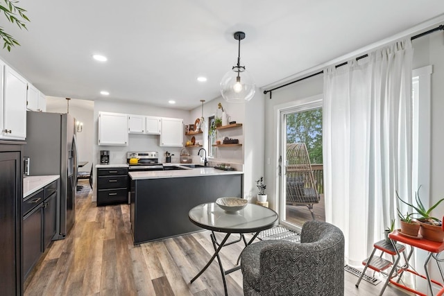 4180 Reading Rd, Eagan, MN 55123 - kitchen featuring stainless steel appliances, light countertops, a sink, light wood-type flooring, and white cabinetry