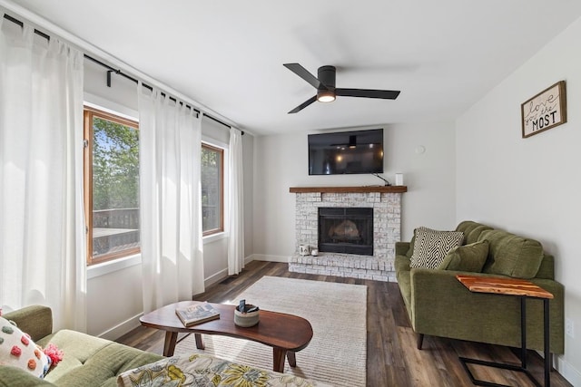 4180 Reading Rd, Eagan, MN 55123 - living room featuring a ceiling fan, a fireplace, dark wood-type flooring, and baseboards