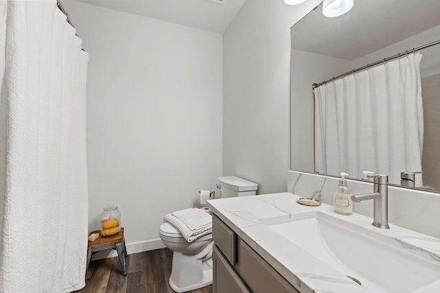 4180 Reading Rd, Eagan, MN 55123 - bathroom with wood finished floors, toilet, vanity, and baseboards