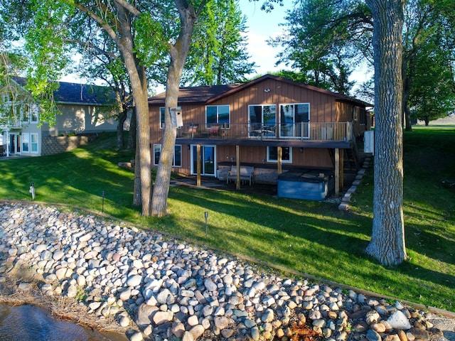 28604 Shore Dr, Starbuck, MN 56381 - back of house featuring a hot tub, a lawn, a deck, and a patio