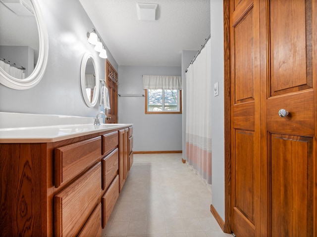28604 Shore Dr, Starbuck, MN 56381 - bathroom featuring baseboards, vanity, and a textured ceiling