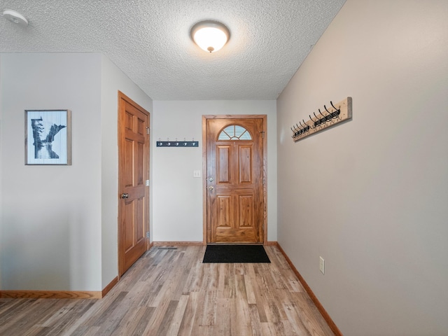 28604 Shore Dr, Starbuck, MN 56381 - entryway featuring light wood-style floors, a textured ceiling, and baseboards