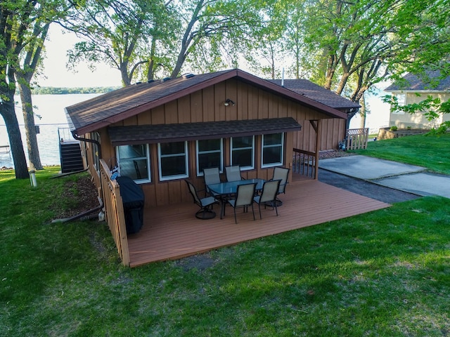 28604 Shore Dr, Starbuck, MN 56381 - rear view of property with roof with shingles, a wooden deck, a yard, and outdoor dining area