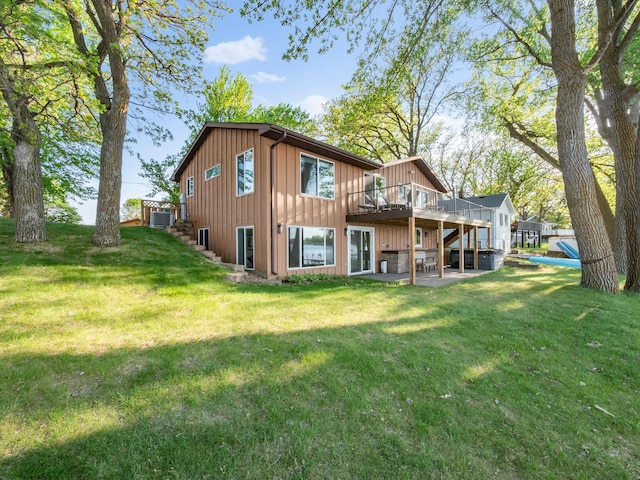 28604 Shore Dr, Starbuck, MN 56381 - back of house featuring board and batten siding, a deck, a patio area, stairway, and a lawn