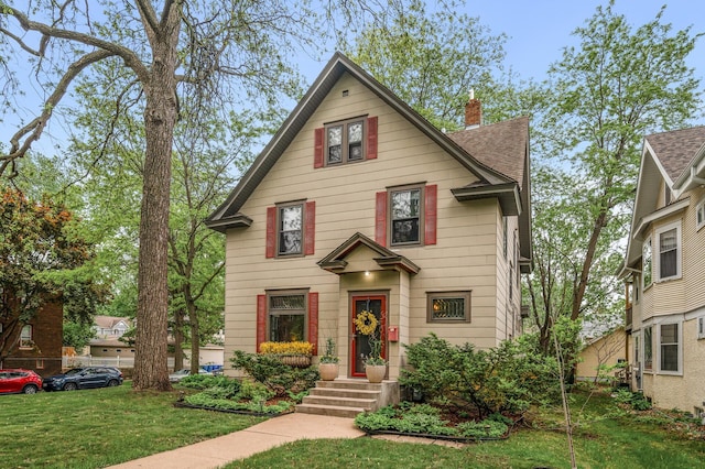 traditional style home with a chimney and a front lawn
