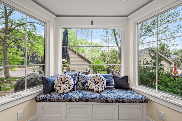 sunroom with healthy amount of natural light and baseboards