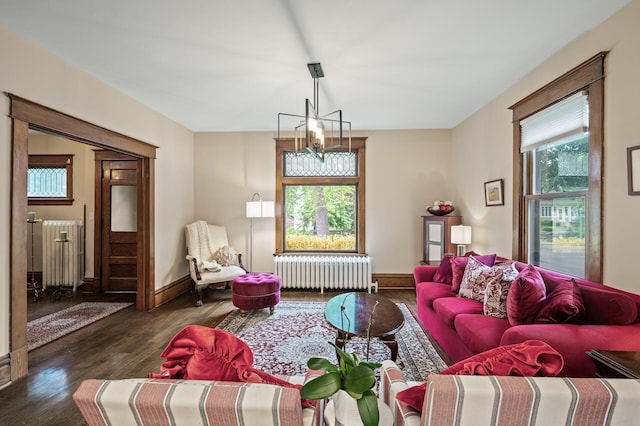living area with radiator heating unit, wood finished floors, and baseboards