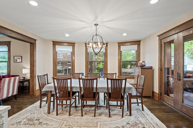 dining space with french doors, wood finished floors, recessed lighting, healthy amount of natural light, and a chandelier