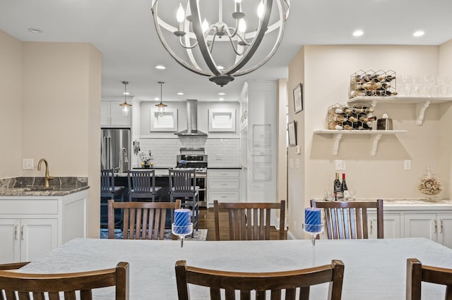 dining space featuring recessed lighting and a chandelier