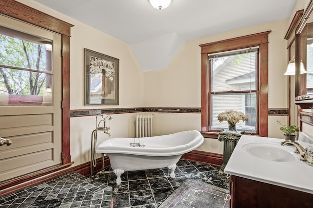 full bath with baseboards, a soaking tub, vanity, radiator heating unit, and marble finish flooring