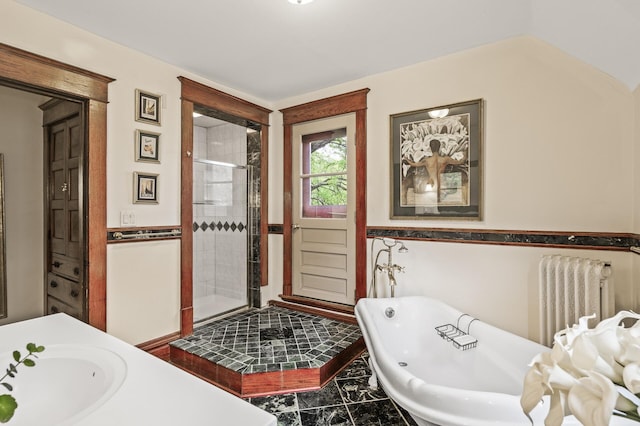 full bathroom featuring radiator, a stall shower, a soaking tub, a sink, and marble finish flooring