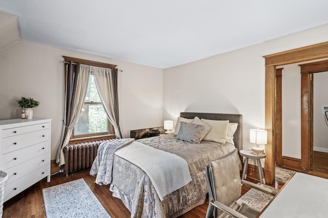 bedroom featuring wood finished floors and radiator