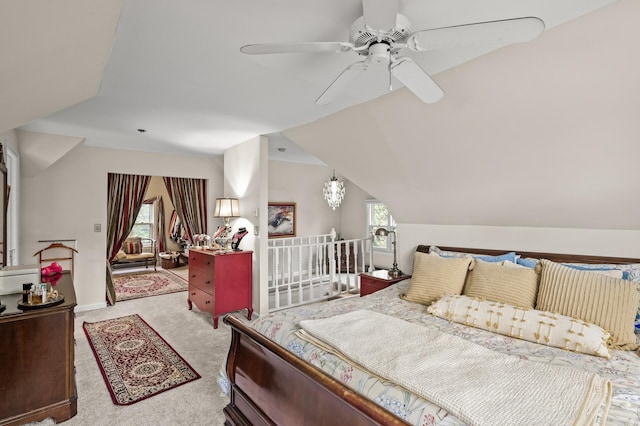 carpeted bedroom featuring vaulted ceiling and a ceiling fan