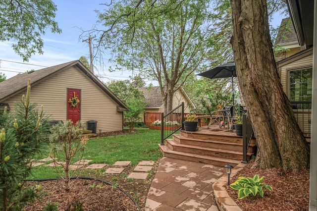 view of grassy yard featuring a wooden deck