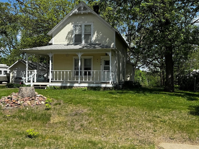208 Cush St, Jackson, MN 56143 - victorian-style house featuring a porch, a front lawn, and a chimney