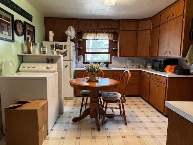 208 Cush St, Jackson, MN 56143 - kitchen with washer / dryer, light floors, light countertops, black microwave, and open shelves