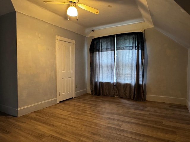 208 Cush St, Jackson, MN 56143 - unfurnished room with lofted ceiling, wood finished floors, baseboards, and a ceiling fan