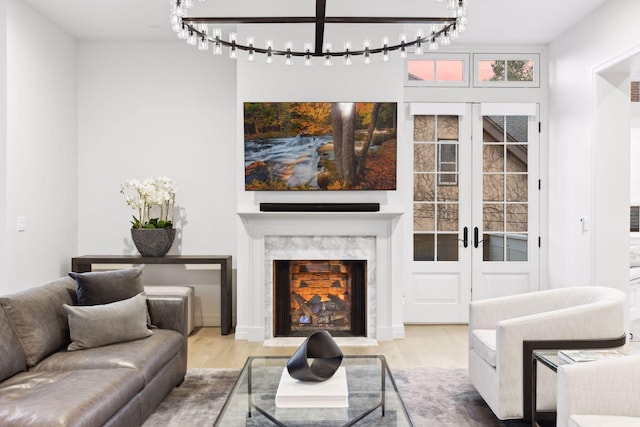 1301 Mount Curve Ave, Minneapolis, MN 55403 - living area featuring wood finished floors, french doors, a chandelier, and a fireplace