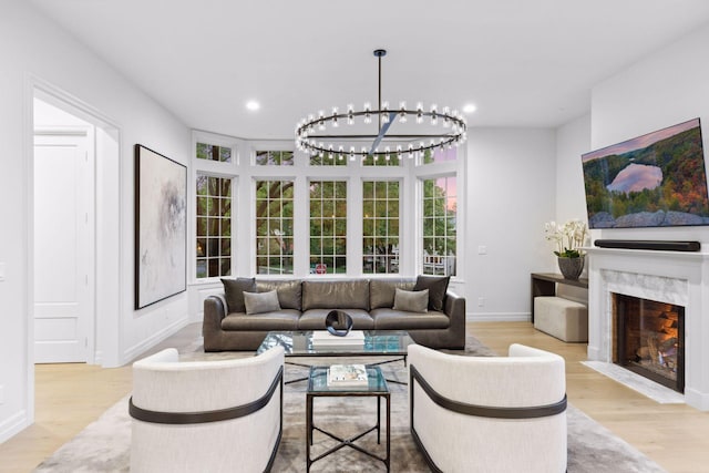 1301 Mount Curve Ave, Minneapolis, MN 55403 - living area featuring wood finished floors, a chandelier, a premium fireplace, recessed lighting, and baseboards