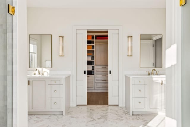 1301 Mount Curve Ave, Minneapolis, MN 55403 - full bath with two vanities, a spacious closet, and marble look tiles