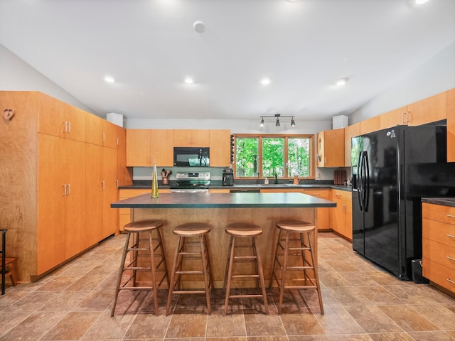 2536 Sandhill Ln NE, Carlos Twp, MN 56308 - kitchen featuring black appliances, lofted ceiling, dark countertops, a kitchen bar, and a center island
