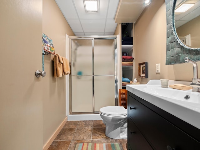 2536 Sandhill Ln NE, Carlos Twp, MN 56308 - bathroom with a drop ceiling, a stall shower, baseboards, vanity, and toilet