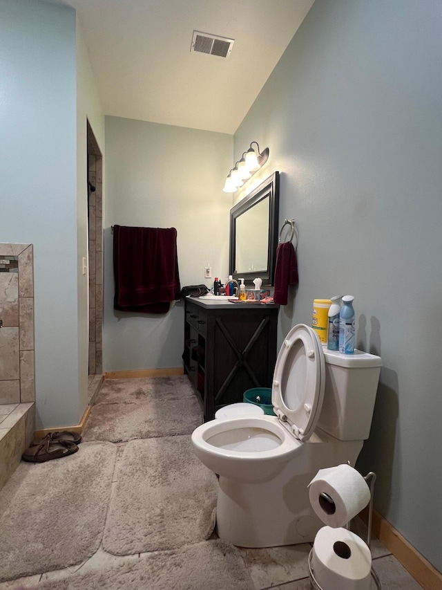 34373 State Highway 7, Foster Twp, MN 56225 - bathroom with toilet, baseboards, tiled shower, and vanity
