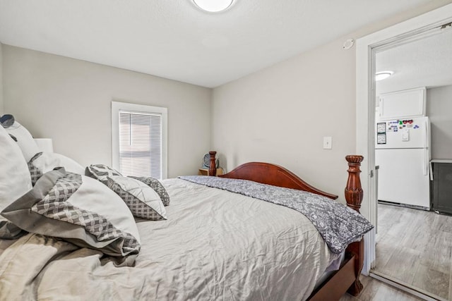 4959 5th St NE, Columbia Heights, MN 55421 - bedroom featuring freestanding refrigerator and wood finished floors