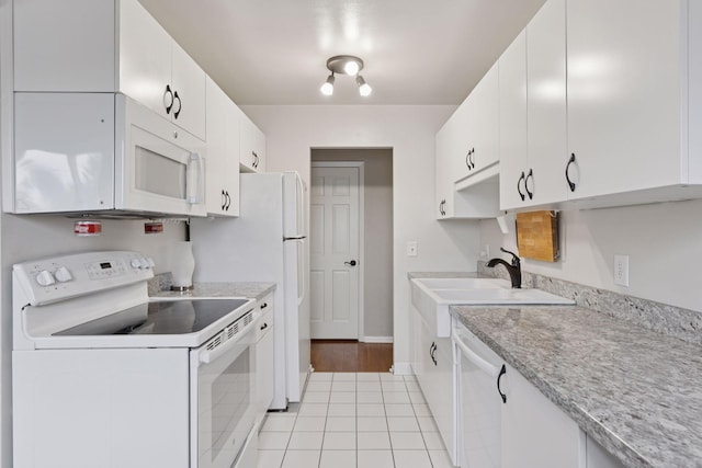 1540 Ashland Ave Unit 3, Saint Paul, MN 55104 - kitchen with white appliances, a sink, light countertops, baseboards, and white cabinets
