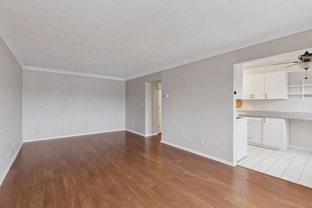 1540 Ashland Ave Unit 3, Saint Paul, MN 55104 - unfurnished living room with ceiling fan, light wood-style floors, and baseboards