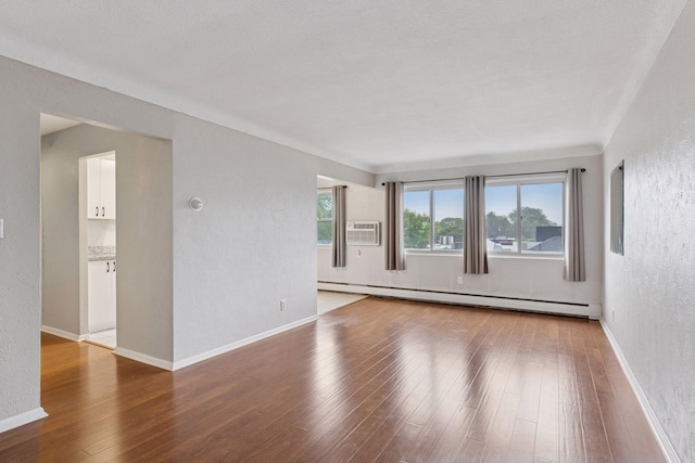 1540 Ashland Ave Unit 3, Saint Paul, MN 55104 - spare room featuring a baseboard radiator, a textured wall, hardwood / wood-style flooring, and baseboards