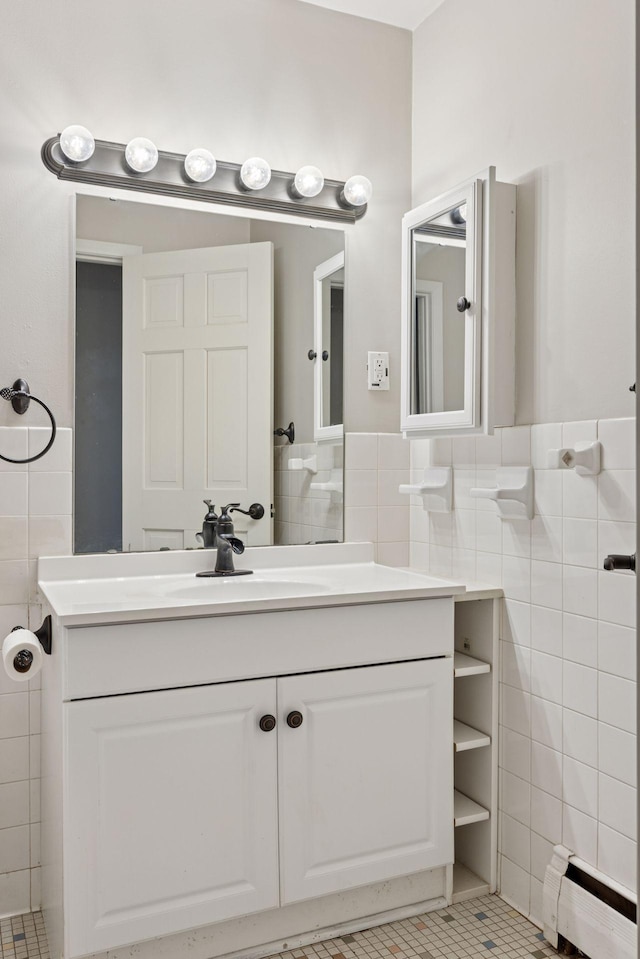 1540 Ashland Ave Unit 3, Saint Paul, MN 55104 - bathroom featuring a baseboard heating unit, tile walls, vanity, tile patterned floors, and wainscoting