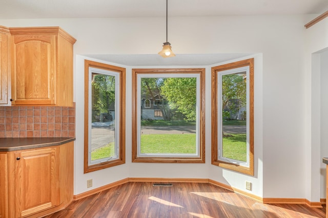 12761 Ethelton Way, Apple Valley, MN 55124 - unfurnished dining area with healthy amount of natural light, wood finished floors, and baseboards