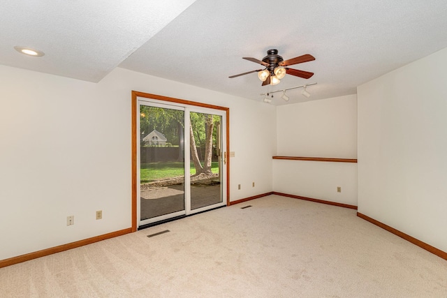 12761 Ethelton Way, Apple Valley, MN 55124 - unfurnished room with rail lighting, carpet floors, ceiling fan, baseboards, and a textured ceiling