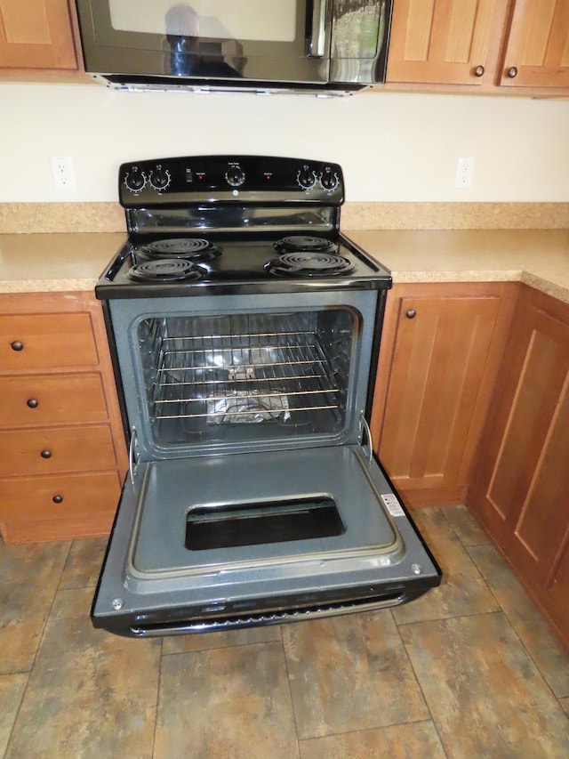 47375 Gone Golfin, Garrison, MN 56450 - kitchen view of black electric range oven, stainless steel microwave, and light countertops