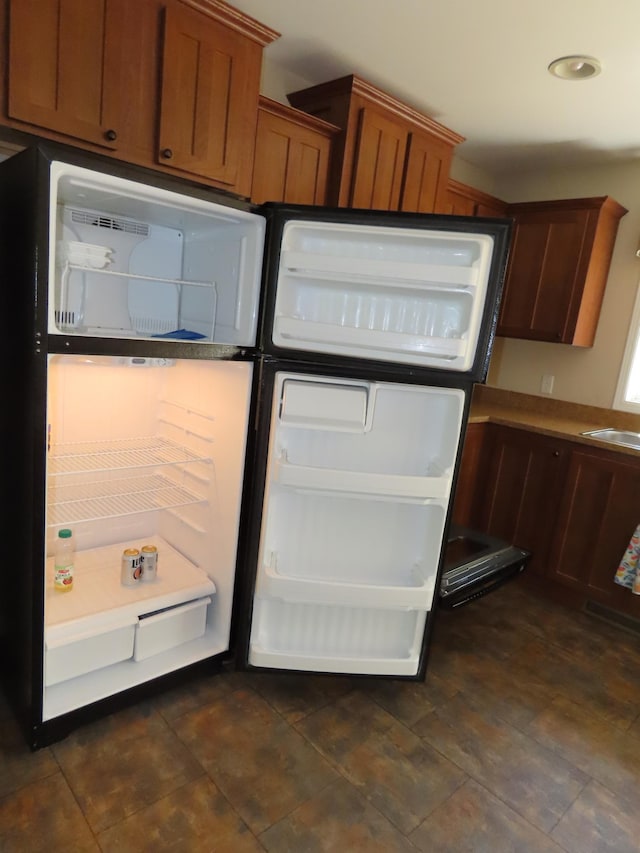 47375 Gone Golfin, Garrison, MN 56450 - kitchen featuring fridge and brown cabinetry
