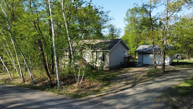 47375 Gone Golfin, Garrison, MN 56450 - view of side of property featuring a garage, an outdoor structure, and driveway
