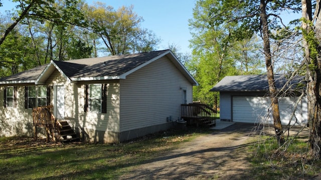 47375 Gone Golfin, Garrison, MN 56450 - view of property exterior featuring an outbuilding, a garage, and roof with shingles
