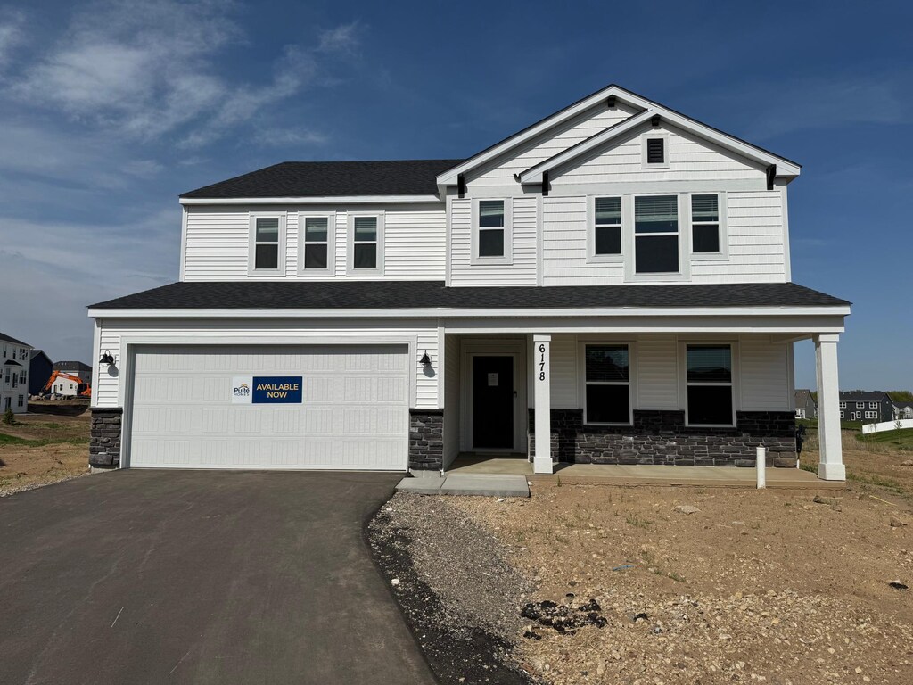 6178 Highland Hills Cir S, Cottage Grove, MN 55016 - craftsman inspired home featuring asphalt driveway, covered porch, a garage, and stone siding