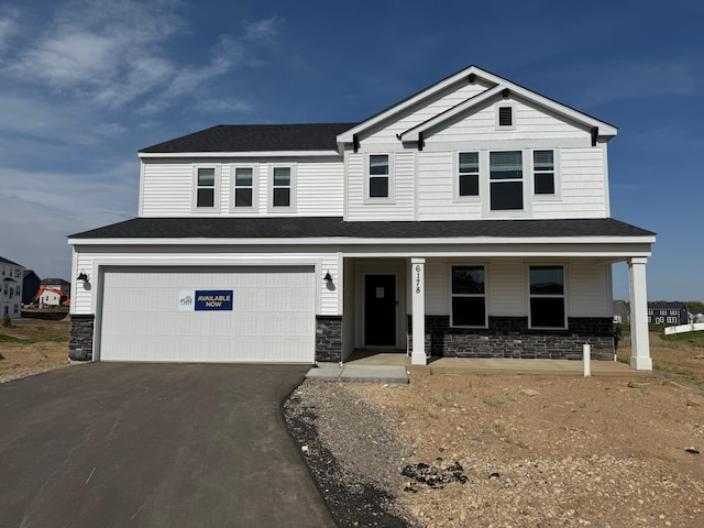 6178 Highland Hills Cir S, Cottage Grove, MN 55016 - craftsman inspired home featuring asphalt driveway, covered porch, a garage, and stone siding