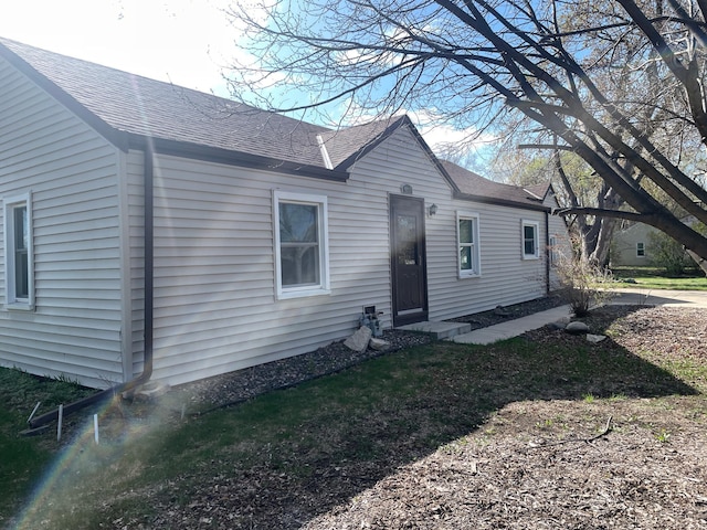 back of property featuring roof with shingles