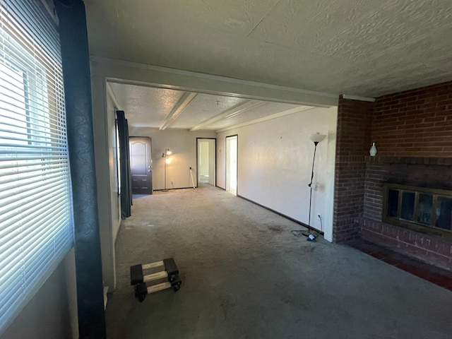 unfurnished living room featuring carpet flooring, a fireplace, a textured ceiling, and baseboards