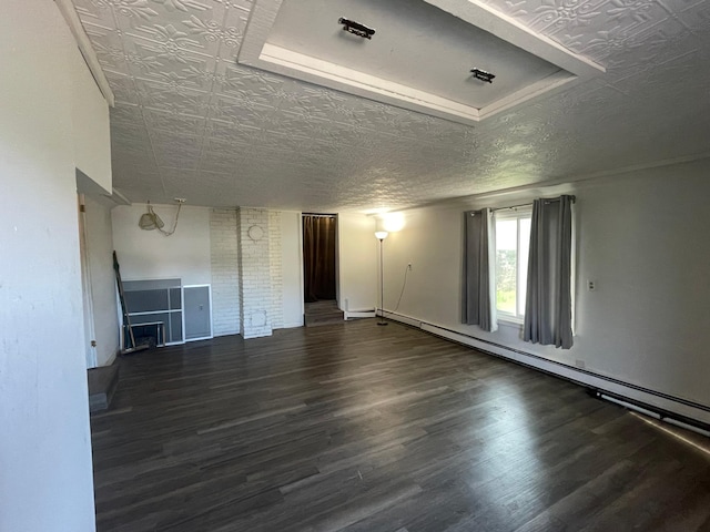 unfurnished living room with a baseboard heating unit, wood finished floors, and an ornate ceiling