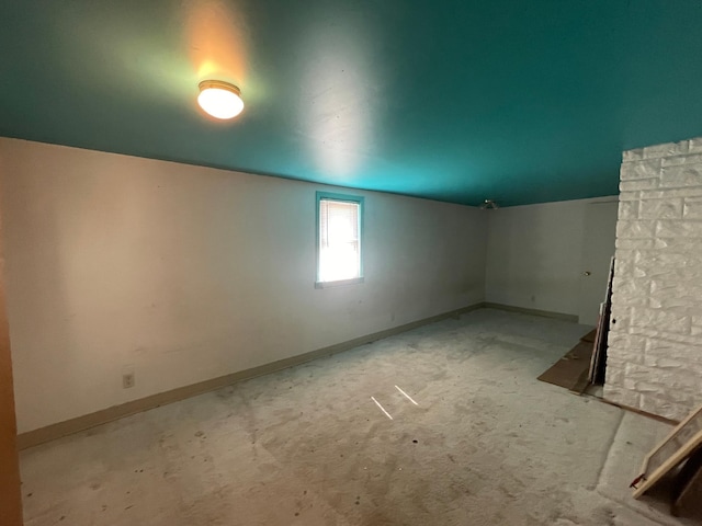 spare room with baseboards and carpet