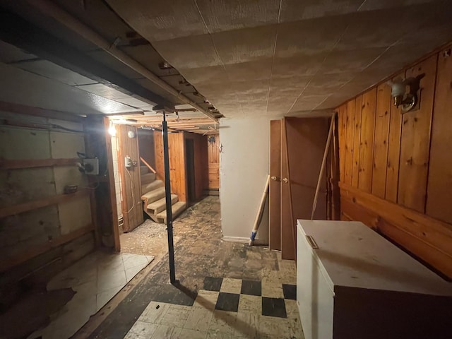unfinished below grade area with stairs and wood walls