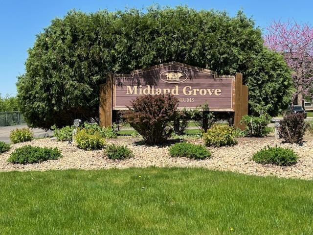 community / neighborhood sign with a yard