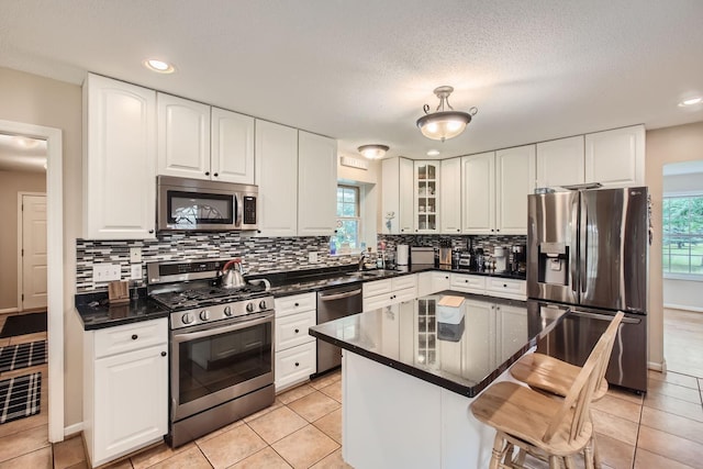 18046 Zodiac St NE, Columbus, MN 55025 - kitchen featuring appliances with stainless steel finishes, a sink, dark countertops, tasteful backsplash, and recessed lighting