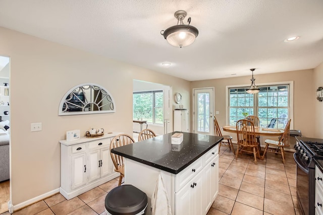 18046 Zodiac St NE, Columbus, MN 55025 - kitchen featuring gas range, white cabinetry, light tile patterned floors, decorative light fixtures, and recessed lighting