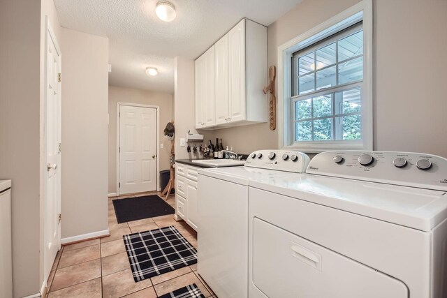 18046 Zodiac St NE, Columbus, MN 55025 - laundry room with cabinet space, light tile patterned flooring, independent washer and dryer, baseboards, and a textured ceiling